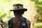 Old and tanned fisherman with a hat on a river surrounded by jungle in Myanmar