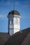 Old Tarnished Cupola on Roof Under Blue Skies