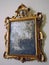 old tarnished gold framed mirror with ornate baroque details