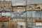 Old tattered insulation panels, torn nylon burlap sacks and wooden plamks on a wall of abandoned building