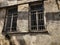 Old Tbilisi architecture, yard, windows in summer day. Old brick wall