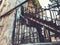 Old Tbilisi architecture, yard, windows in summer day. Old iron stairs