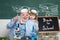 Old teacher near chalkboard in school classroom. Knowledge day. A Biology demonstration.