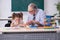 Old teacher and schoolgirl in the school