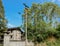 Old telegraph pole outside walled rundown 1960s` apartment building