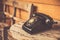 Old telephone black color on wood table.