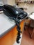 Old telephone on the table with tangled telephone cord