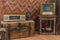 Old television, gas lantern and retro radio on wooden coffe table. Vintage color tone style