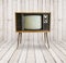 Old television on wood background.