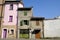 Old terraced houses along a street. Degraded facades of houses of different heights