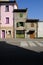 Old terraced houses along a street. Degraded facades of houses of different heights