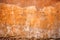 An old terracotta stone wall background texture in brown tones