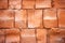 An old terracotta stone wall background texture in brown tones