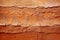An old terracotta stone wall background texture in brown tones