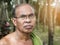 Old thai gardener man in rubber tree garden