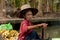 Old thai woman selling fruit at floating market, Damnoen Saduak, Thailand