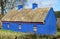 Old thatched blue cottage in rural setting, County Sligo, Ireland