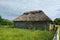 Old thatched double door barn In a field