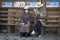Old tibetan people in traditional clothes sit on a bench nearby Jokhang temple