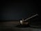 Old Tibetan singing bowl on wooden base, black background. Music therapy