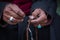 Old Tibetan woman holding buddhist rosary, Ladakh, India. Hand and rosary