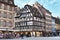 Old timbered frame house residential buildings in historical city center at square in front of Cathedral of Strasbourg