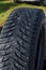 Old tires, car tire with spikes. grass background.