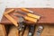 Old tools. Chisels, a screwdriver and a square are on the shelf. Planers on a wooden table