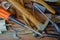 Old tools, hammer, screwdrivers, wrenches, wire wooden background