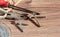 Old tools on a wooden background. Pliers, screwdriver, nails and wire on a wooden background