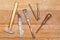 Old tools on wooden boards. Hammer, knife, screwdriver, file, drill.