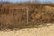 Old torn rusty football goal on an empty sandy beach. The concept of nostalgia. Old soccer goal in the field