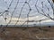 Old torn soccer net on a deserted beach