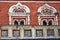 Old tower of red bricks decorated by ceramic tiles.