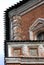 Old tower of red bricks decorated by ceramic tiles.