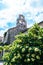 The Old Town of Budva, Montenegro - an old stone church adhering to the fortress of Budva to the Adriatic Sea. Flowers and palms