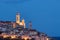 The old town of Cervo, Liguria, Italy, with the beautiful baroque church arising from the houses. Clear blue sky.