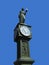 Old town clock and figure.