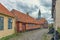 The old town of Ebeltoft with a  cobblestone-street and a red half-timbered house