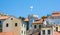 Old town gate with the small clocktower surrounded by old houses