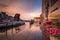 Old town in Gdansk with historical port crane over Motlawa river at rainy sunset, Poland