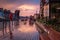 Old town in Gdansk with historical port crane over Motlawa river at rainy sunset, Poland