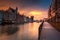 Old town in Gdansk with historical port crane over Motlawa river at rainy sunset, Poland