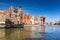 Old town of Gdansk with historical port crane reflected in Motlawa river, Poland