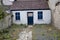 Old town house in Ireland, White walls, bright vibrant blue, Wooden window frames and door