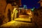 Old town main square at night with arched doors. Santillana del Mar