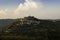 Old town of Motovun in Istria rises up on hill in late summer sunset with vineyards in foreground