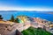 Old town of Nafplion in Greece view from above with tiled roofs, small port and bourtzi castle on the Mediterranean sea.