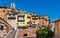 Old town south slope with historic tenement houses and walls over Bulevard Fragonard street in perfumery city of Grasse in France