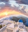 Old Town of Thira on the island Santorini, white church against colorful sunset in Greece